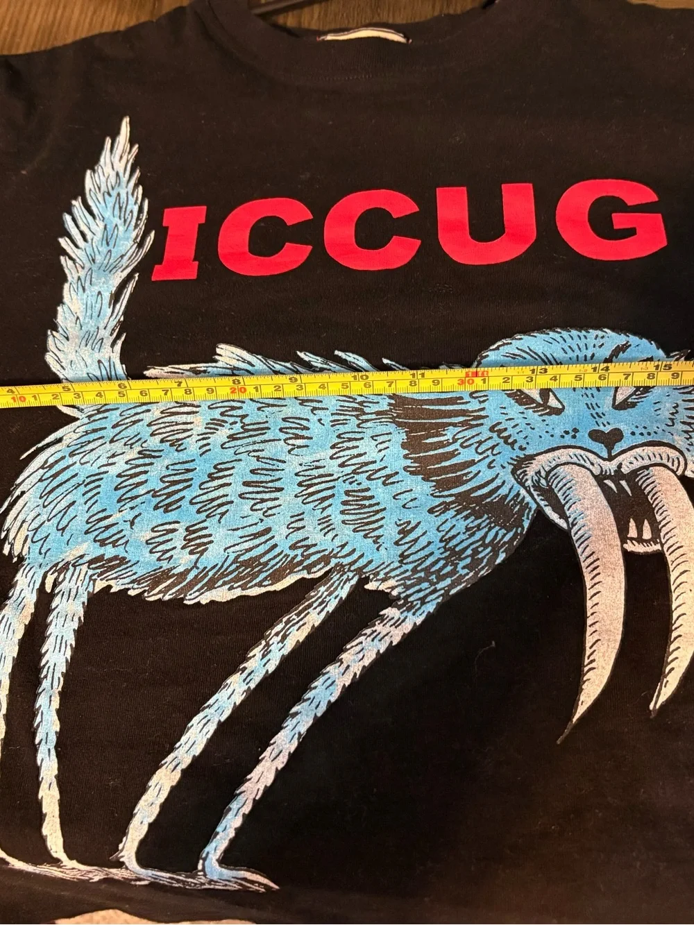 Mens Black Graphic Tee with Blue Creature and Red Logo